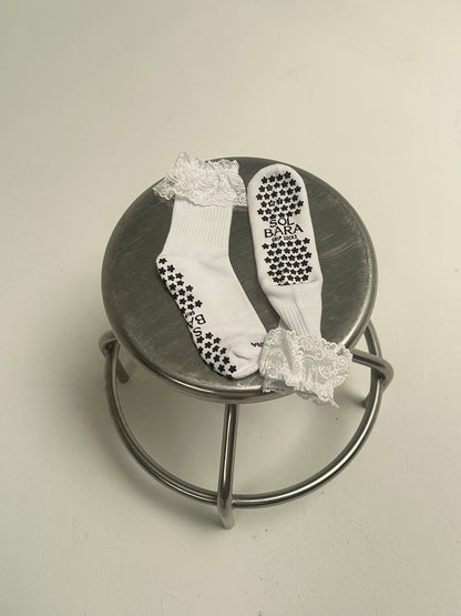 The Lacey bamboo grip socks showing the silicone floral grip sole and ivory lace cuff
